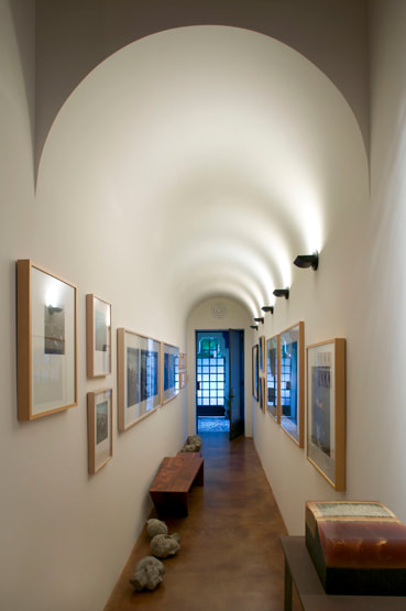 Indirect lighting features barrel vault while illuminating the art at Barry A. Berkus, AIA residence.